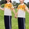 mẫu áo đồng phục mầm non màu trắng cam